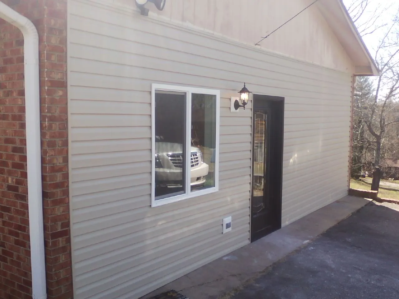 New vinyl siding and entry door on a room addition in Chelsea